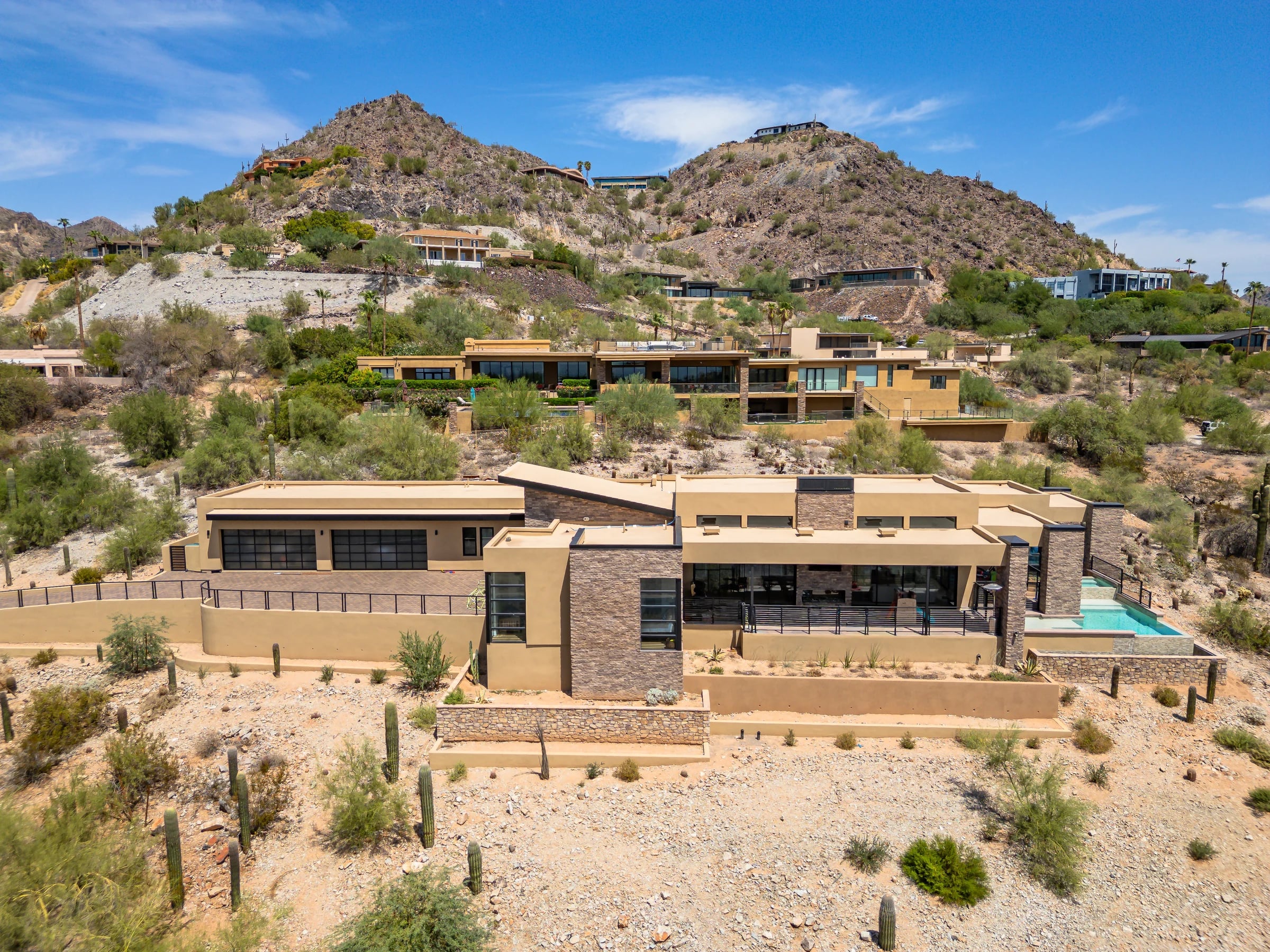 The Desert Crest residence and pool beneath a rugged Arizona mountainside.