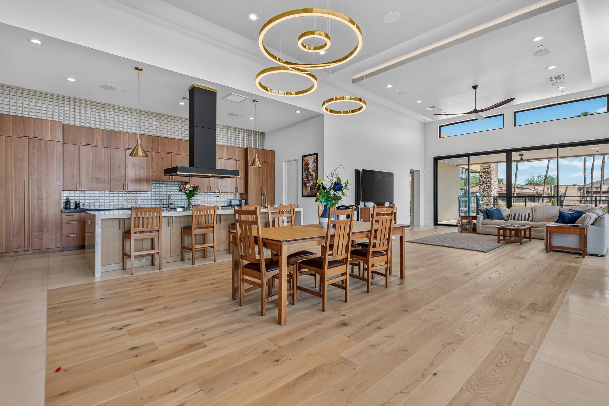 A bright kitchen and dining space beneath a vaulted ceiling.