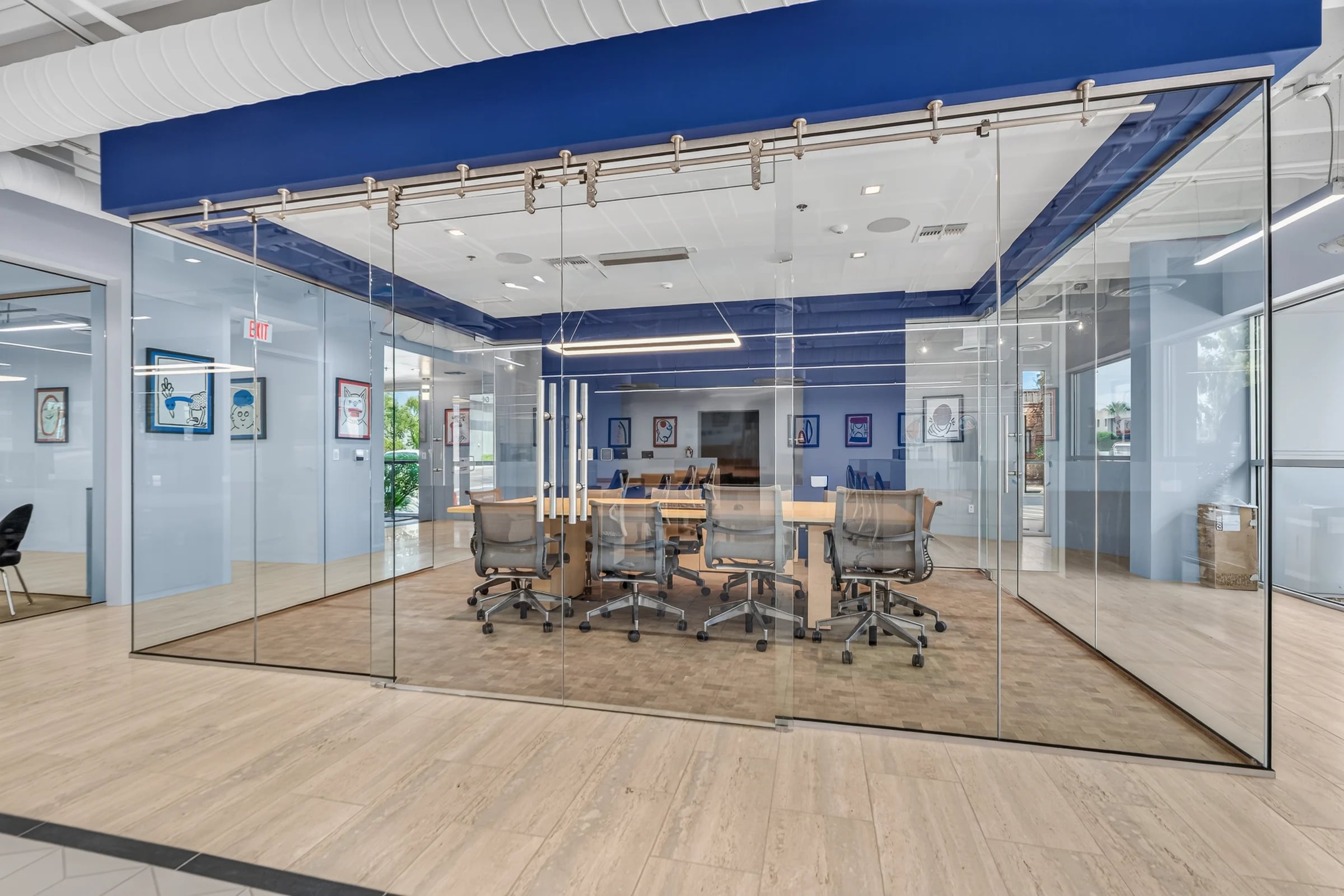 A glass-walled conference room with a navy ceiling.