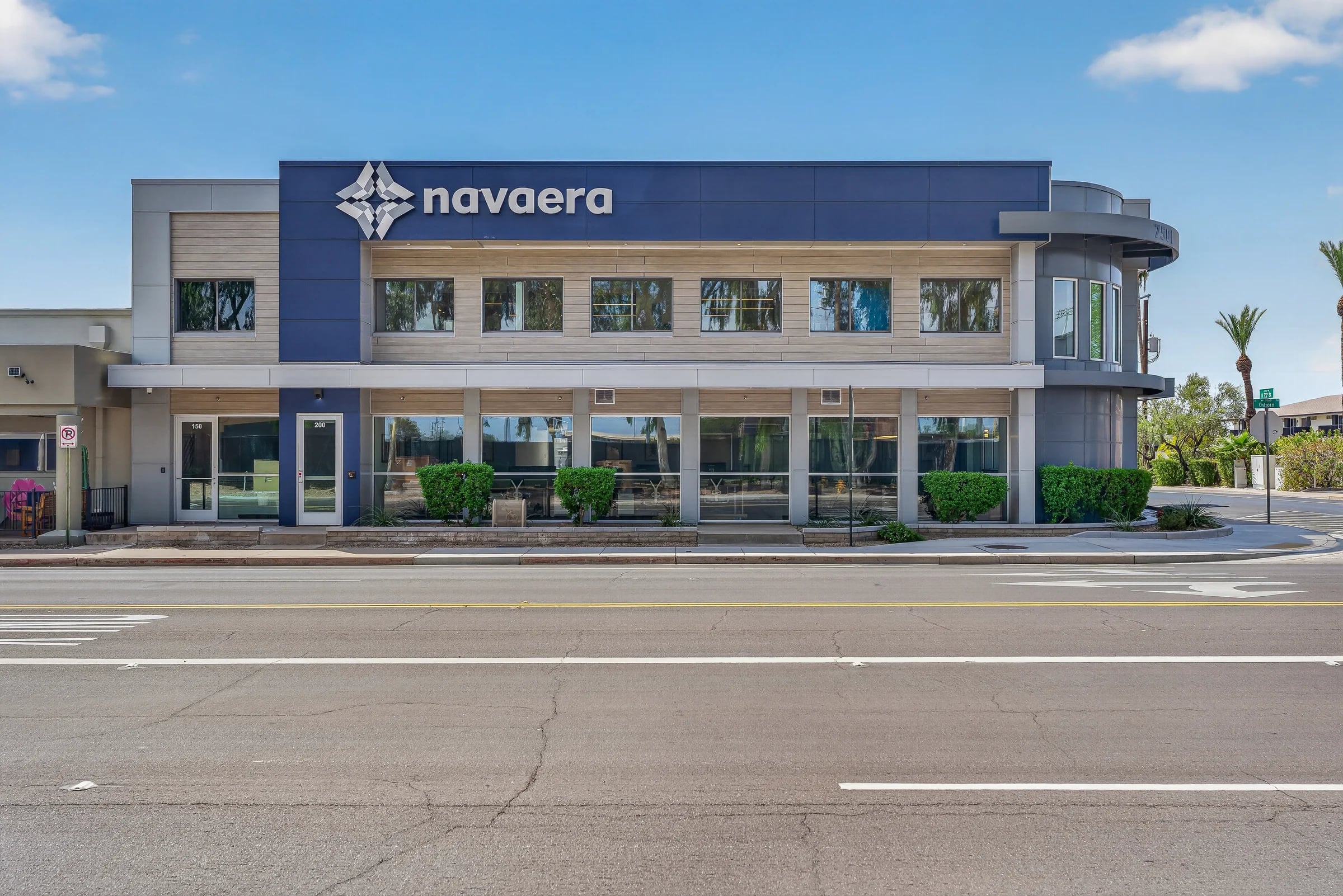 The Navaera office building on Osborn Road, with a curved glass corner.