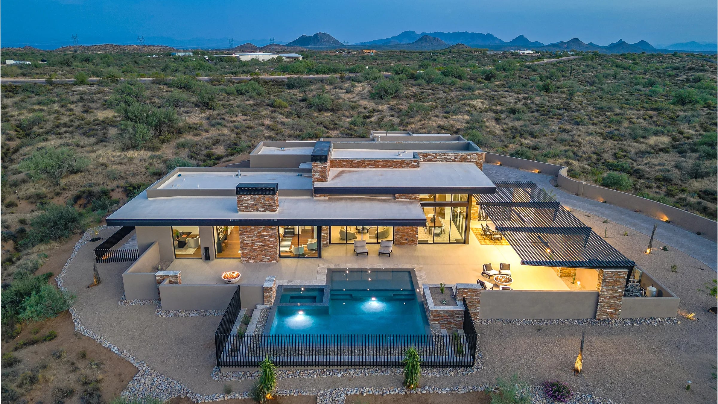 The Salero residence and its illuminated pool sit within the Sonoran Desert at dusk.