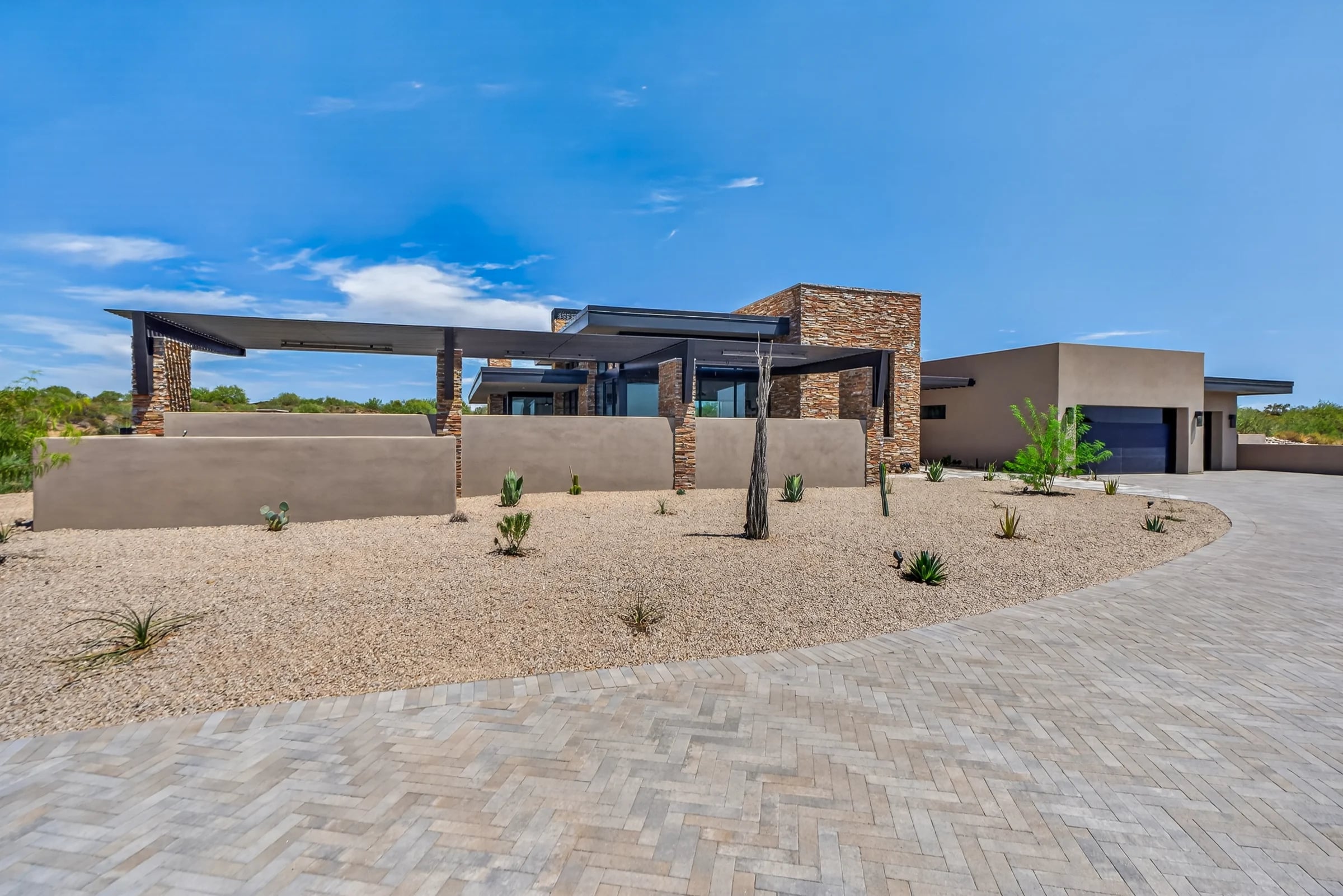Natural stone, clean rooflines and desert planting at the Salero residence.