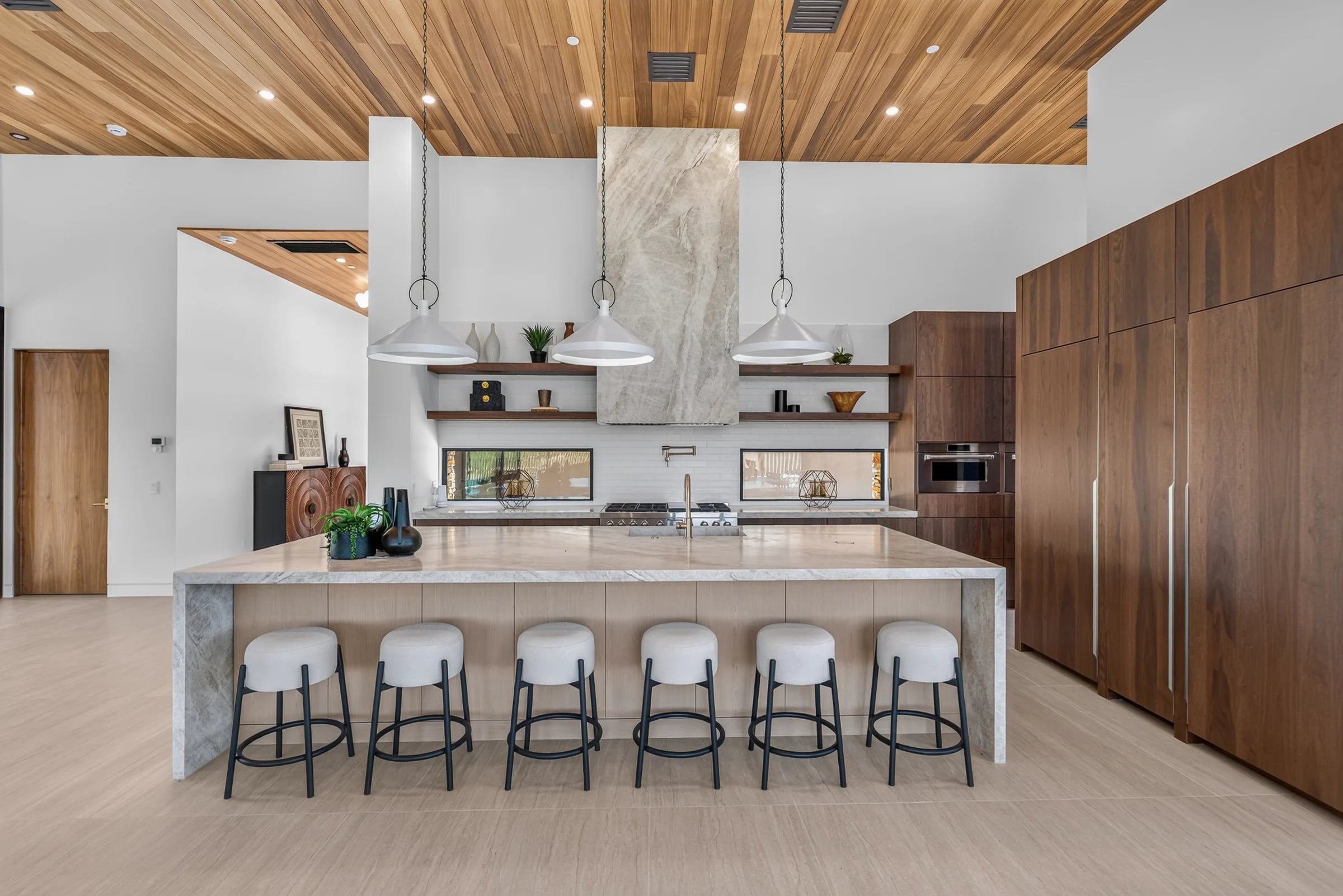 A stone island, timber cabinetry and wood ceiling in the Salero kitchen.